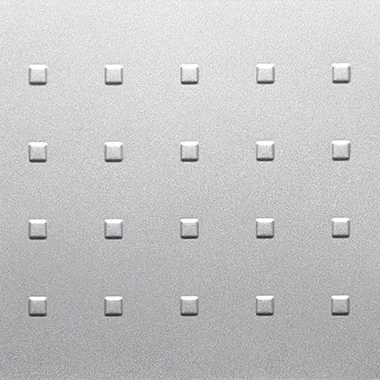 Close up of a metallic surface with a grid of small raised square bumps evenly spaced in rows and columns
