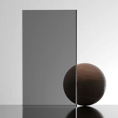 Abstract minimalist sculpture a tall gray rectangle leaning against a dark sphere on a glossy surface with a soft gradient background