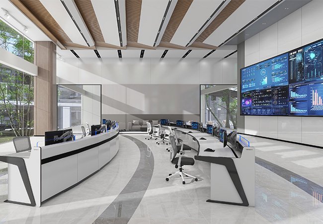 Modern control room with curved white desks, multiple computer stations, and a large wall of screens displaying data