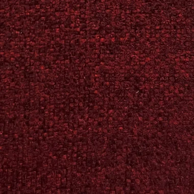 Close up of dark red textured fabric with a subtle weave pattern used as a background material