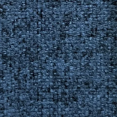 Close up of blue denim fabric with visible diagonal weave and texture