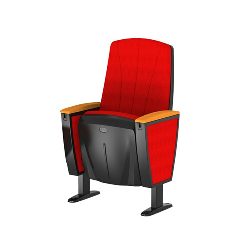 Red upholstered theater seat with wooden armrests and black metal supports isolated on white background