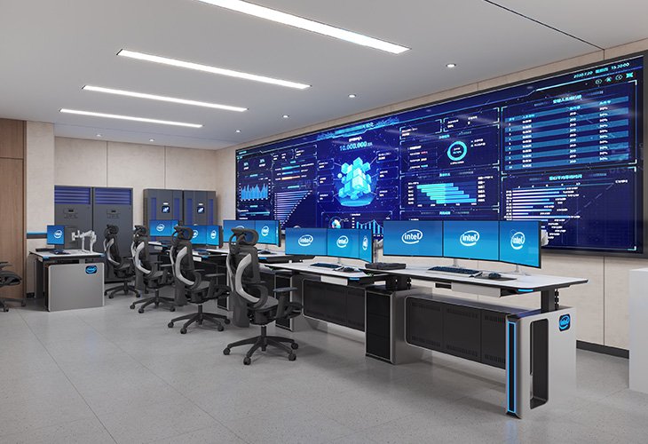 Command center: row of workstations with multiple Intel monitors facing large blue data dashboards on a wall screen.