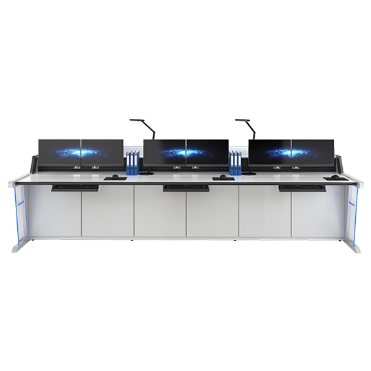 Row of three computer workstations on a long white desk with monitors, keyboards, and storage cabinets underneath.
