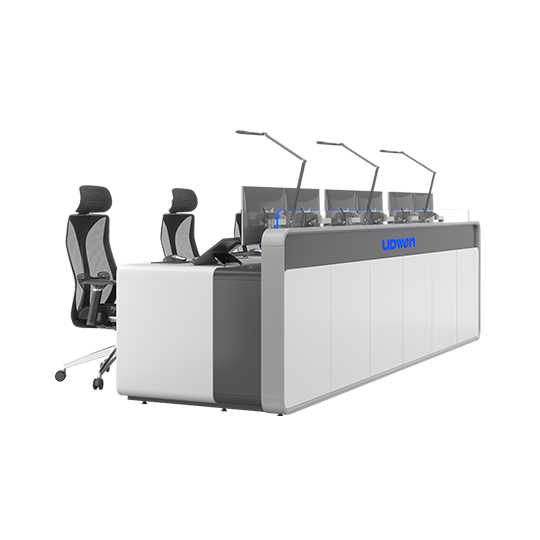 Long gray-and-white conference desk with six workstations, each equipped with monitors, microphone arms, and ergonomic chairs, front branding reads UDWEN.