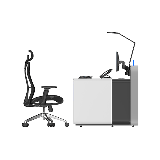 Ergonomic black office chair on wheels beside a two-tone grey and white reception desk with a computer monitor, keyboard, telephone, and an adjustable desk lamp.