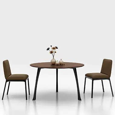 Round wooden dining table with two brown upholstered chairs and a vase of flowers in the center, against a white background.