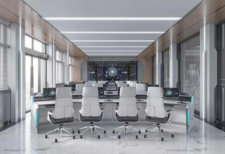 Modern command center with white ergonomic chairs at workstations facing a large digital dashboard.