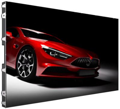 Red sports car shown from a low front-left angle on a dark studio backdrop, dramatic lighting highlighting its curves and front grille.