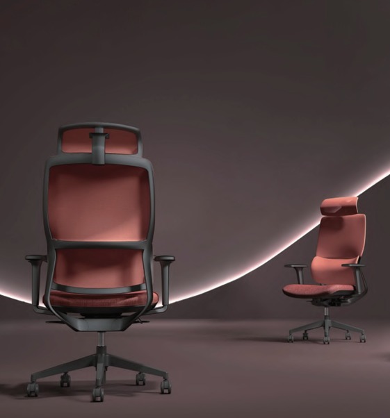 Two red ergonomic office chairs with black frames, one large in the foreground and a smaller chair in the background on a muted purple studio backdrop.